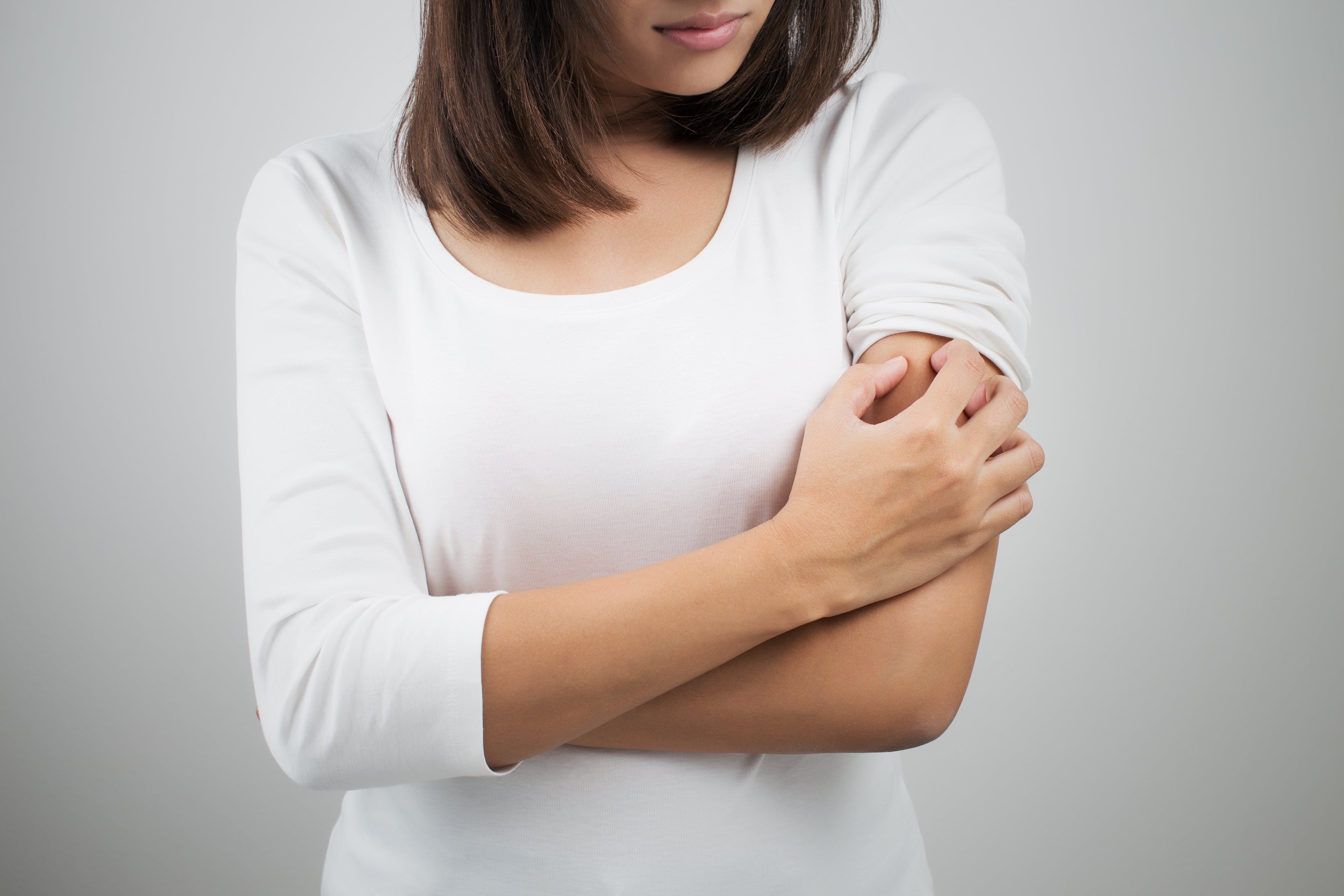 Woman itching her arm by eddows via Adobe Stock.